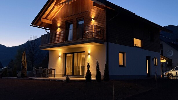 A two-story house with a balcony, large windows, and a driveway. - New luxury villa—for outdoor adventures in both summer and winter! (Gundersheim)