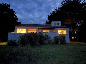 A single-story house with a sloped roof, a small attached garage, and a fenced yard. - Ocean view home with fireplace, deck, private hot tub & grill (Sea Ranch)
