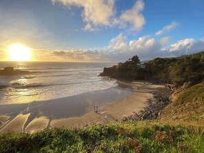 A coastal landscape with a beach, ocean waves, and a sunset. - Gualala 3BR updated coastal home with ocean views & private deck (Gualala)