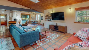 A living room with a sofa, TV, and fireplace.