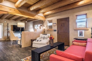 A cozy living room with a sofa, armchair, and a coffee table.