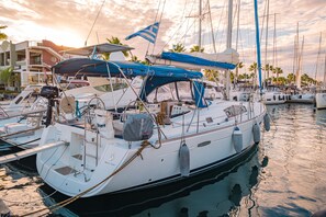 Un puerto deportivo con varios veleros amarrados, mostrando mástiles, velas y aparejo.