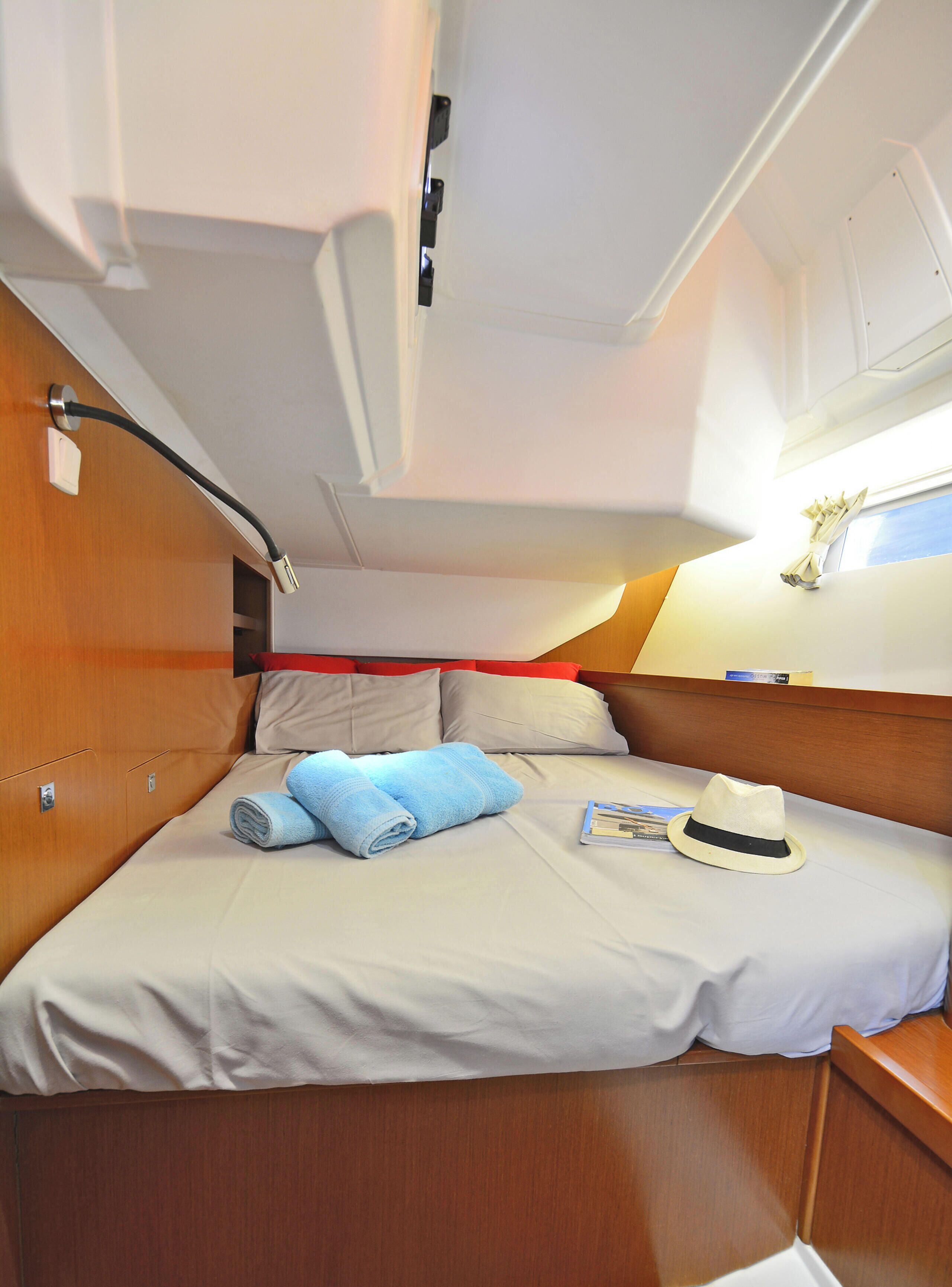 A compact cabin with a bed, a small table, and a window.