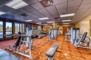 A gym with various exercise machines, a bench, and a patterned carpet. - Angelica's Sorrento Home - Hike & Monte Verde Lake (Angel Fire)