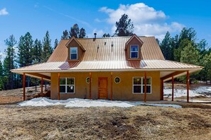 A two-story house with a gabled roof, a covered porch, and a front door. - Angelica's Sorrento Home - Hike & Monte Verde Lake (Angel Fire)