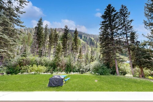 Amazing condo with river & mountain views, hot tub, & wood-burning fireplace