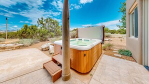 A hot tub in a backyard with a pergola, wooden steps, and a view of the surrounding landscape. - Dos Vistas - Firepit, Hot Tub, Mountain Views (Santa Fe)