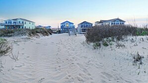 A sandy beach with beachfront houses. - Spacious ocean front house with spectacular views in Nags Head with Elevator (Nags Head)