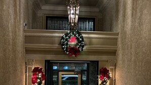 A hotel entrance with a double door, a chandelier, and Christmas decorations. - Luxury Downtown Indy • Walk to NCAA Final Four • On American Legion Mall (Indianapolis)