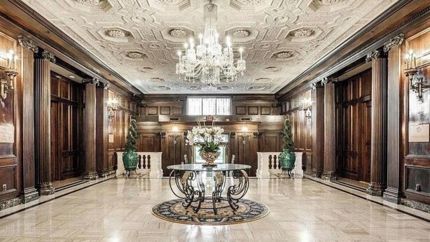 A grand lobby with a marble floor, ornate ceiling, and a central round table with a chandelier. - Luxury Downtown Indy • Walk to NCAA Final Four • On American Legion Mall (Indianapolis)