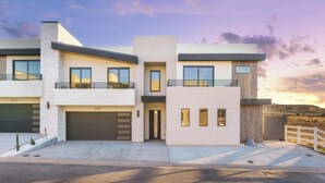 A modern two-story house with a garage, a balcony, and a driveway. - Zion Canyon Mist Resort House (Hurricane)