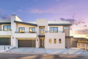 A modern two-story house with a garage, a balcony, and a driveway. - Zion Canyon Mist Resort House (Hurricane)