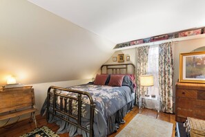 A bedroom with a single bed, a nightstand, a lamp, a dresser, and a window with curtains. - Mount Snow Lake Whitingham Antique Apartment in Jacksonville-Whitingham Vermont (Whitingham)