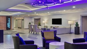 A modern lobby with seating areas, a reception desk, and a sign for 'The Marketplace Express'. - Sleek City-View King Suite Near San Diego’s Best Food & Nightlife (San Diego)