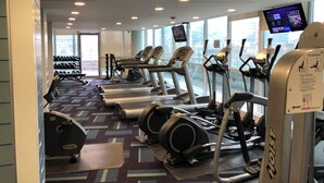 A gym with treadmills, elliptical machines, and a stationary bike. - 2-bedroom apartment in amazing Toronto with cool AC breeze (Toronto)