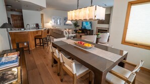 A modern kitchen with a dining area, wooden flooring, and a large window. - Ski/Bike-In Out | Gondola Steps | Mtn Village Core (Mountain Village)