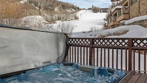 A hot tub on a wooden deck with a snowy mountain view. - Ski/Bike-In Out | Gondola Steps | Mtn Village Core (Mountain Village)