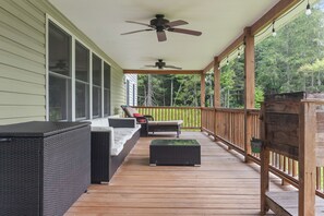 A covered porch with outdoor seating, ceiling fans, and a wooden railing. - Spacious 9BR Catskills Retreat • Views + Game Room (Andes)