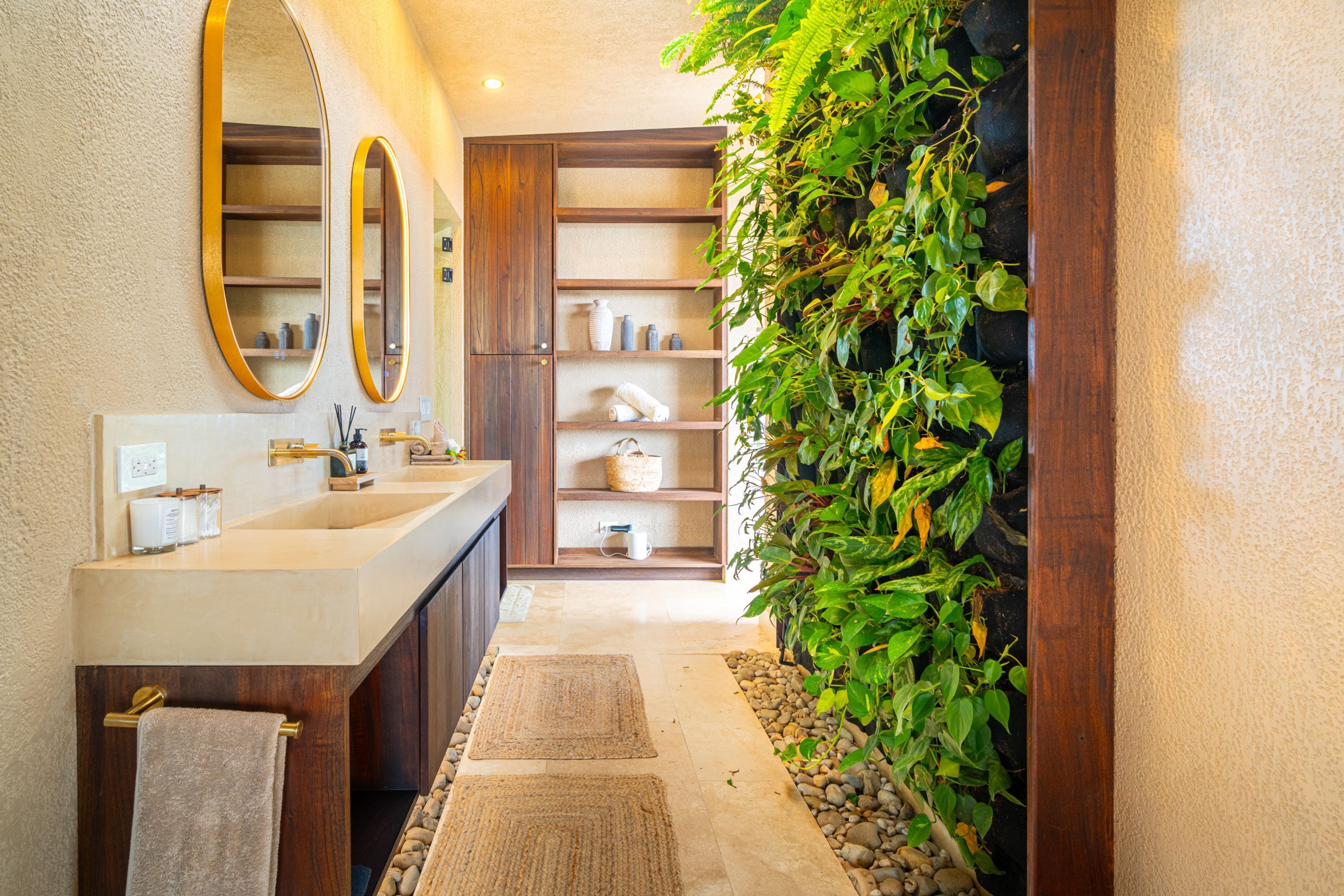 A bathroom with a large mirror, a sink, and a shelf with toiletries.