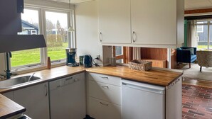 A modern kitchen with a dishwasher, coffee maker, and a wooden countertop. - Gorgeous home in Børkop with WiFi (Børkop)