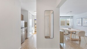 A modern kitchen with white cabinets and a stainless steel refrigerator. - Santurce 3BR · Free Parking · Walk to Calle Cerra Bars (San Juan)