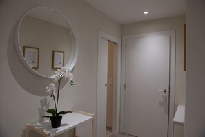 A bathroom with a white sink, a mirror, and a door.