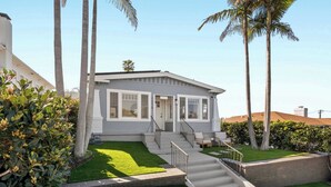 A modern two-story house with a front porch, a staircase, and a well-maintained lawn. - Steps to La Jolla Cove - Private Outdoor Oasis (San Diego)