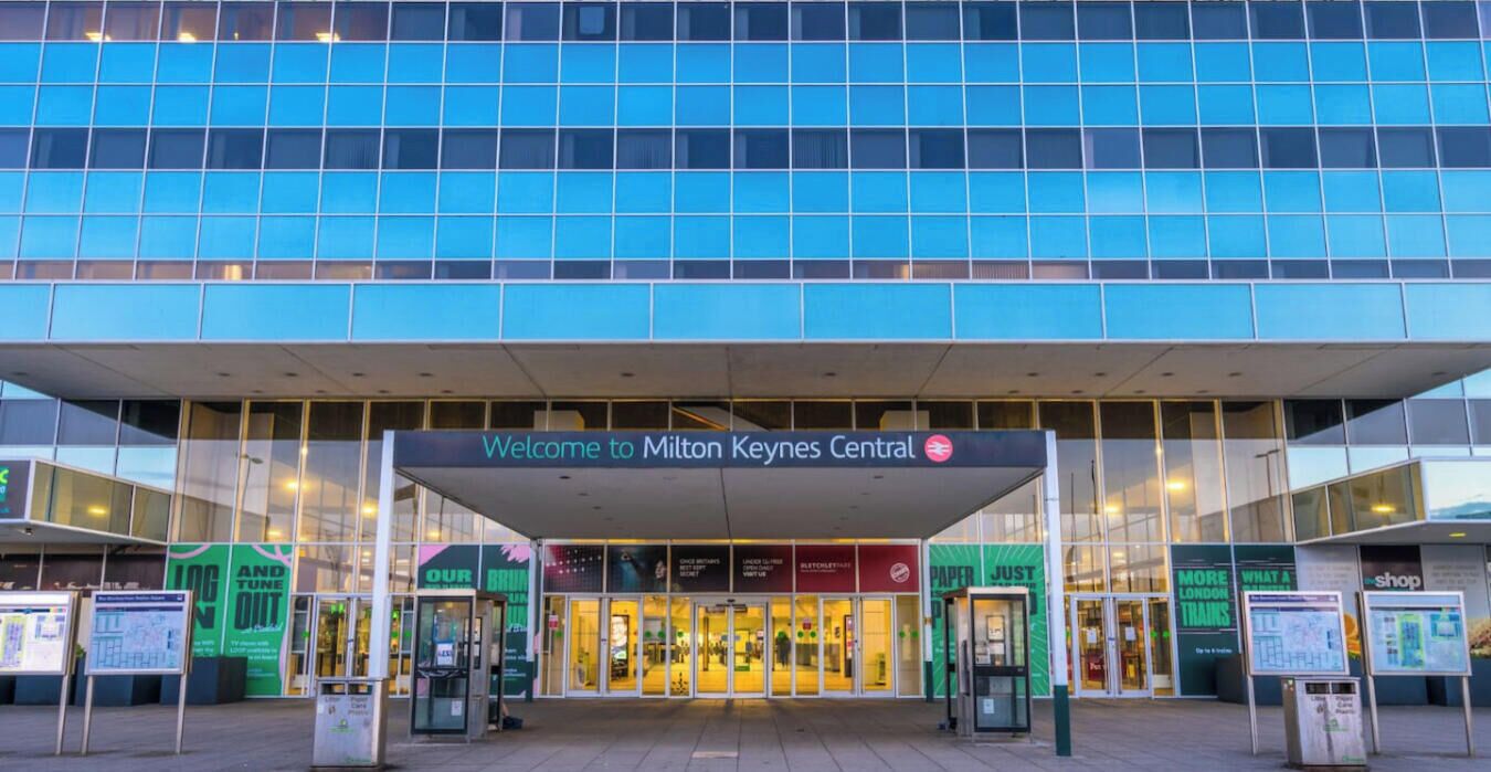 A modern building with a sign reading 'Welcome to Milton Keynes Central.'