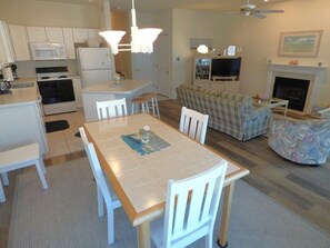 A compact living space with a kitchen, dining area, and living room. - Start planning your Ocean City escape today—your beach retreat is waiting! (Ocean City)