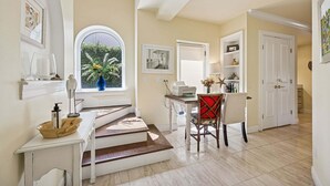 A dining area with a table, chairs, a window with a view, and a staircase leading to another room. - Private pool, 3-bedrooms, 3.5 bathrooms, 2-car garage with EV charger, across from beach access (Fernandina Beach)