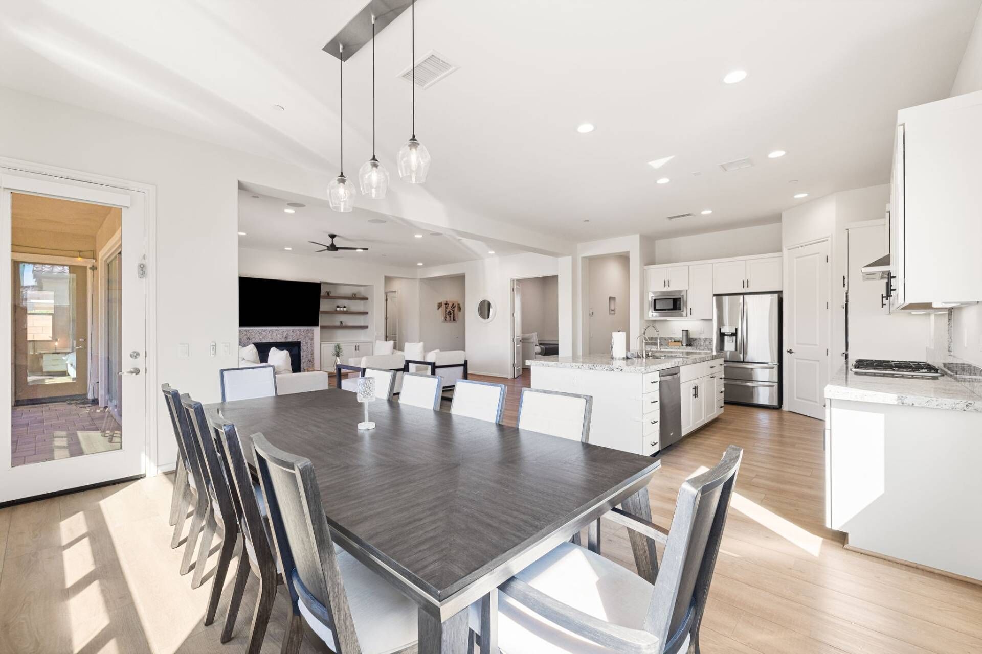 A modern kitchen with white cabinets, stainless steel appliances, and a central island.