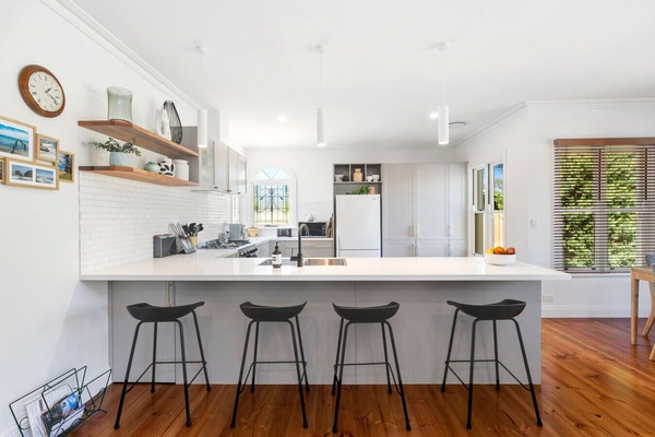 Gorgeous white kitchen with stained glass window and island