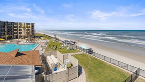 A beachfront hotel with a swimming pool, beach access, and a view of the ocean. - Oceanview Studio w/ Private Balcony, Pools & Beach Access (Daytona Beach Shores)