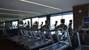 A gym with multiple treadmills, exercise bikes, and cardio machines. - SVS: Strip View Studio | Open Balcony | Pool & Gym | Palms Place (Las Vegas)