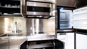 A modern kitchen with stainless steel appliances, including a built-in oven and refrigerator, and a sink with a faucet. - SVS: Strip View Studio | Open Balcony | Resort Amenities | Palms Place (Las Vegas)
