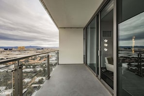 A balcony with a view of a cityscape, a glass door, and a metal railing. - Strip View Studio • Balcony • No Resort Fee • Free Parking • TD53 (Las Vegas)