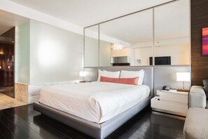 A modern hotel room with a large bed, bedside tables, a mirror, and a view of the hallway. - Strip View Studio • Balcony • No Resort Fee • Free Parking • TD53 (Las Vegas)