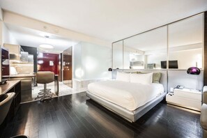A modern hotel room with a large bed, a desk, a chair, a mirror, and a wardrobe. - Strip View Studio • Balcony • No Resort Fee • Free Parking • TE20 (Las Vegas)