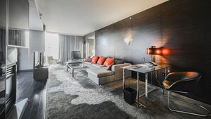 A modern living room with a sofa, coffee table, and a TV. - SVS: High Floor 1BD | Full Kitchen | Jetted Tub | Sleeps 4 | Palms Place (Las Vegas)