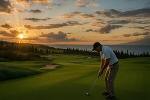 A golf course with a sunset view, a body of water, and a forested area. - Kapalua Ridge Villas | Ocean View 1 BR, Sleeps 4 | Car Incl. w/ 6+ Nights | KRV-311 by KBM (Lahaina)