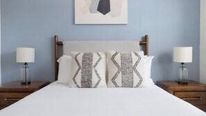 A neatly made bed with two pillows, a headboard, and two bedside tables with lamps. - Landing | Incredible 1BD, Gym, Clubhouse (Austin)