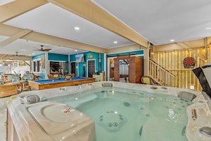 A spa area with a hot tub, a pool table, and a dartboard. - Luxury Oceanfront Escape w/ Spa & Chef's Kitchen (Surfside Beach)