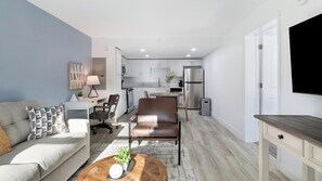 A modern apartment with a living room, dining area, and kitchen. - Landing | Stylish 1BD, Clubhouse, Gym (Kissimmee)