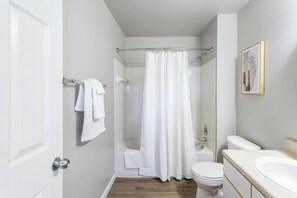A bathroom with a shower, toilet, and sink. - Landing | Incredible 2BD, Clubhouse, Gym (Tallahassee)