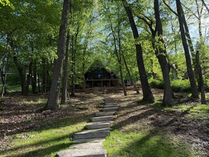 A wooden cabin surrounded by trees with a stone staircase leading to it. - New, Modern, Lakefront, Close to Wisp (McHenry)