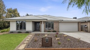 A modern two-story house with a garage, a front yard with a garden bed, and a mailbox. - Summer Breeze - 10 mins to Barwon Heads & Torquay! (499552) (Armstrong Creek)