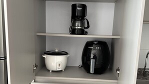 A kitchen with a coffee maker, slow cooker, and electric kettle on open shelves. - Enjoy a peaceful escape in the Coffee Region. (pereira)