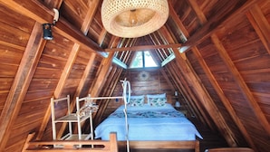 A wooden room with a bed, a hanging light fixture, and a window. - D'Cabin Villa Uluwatu (Pecatu)