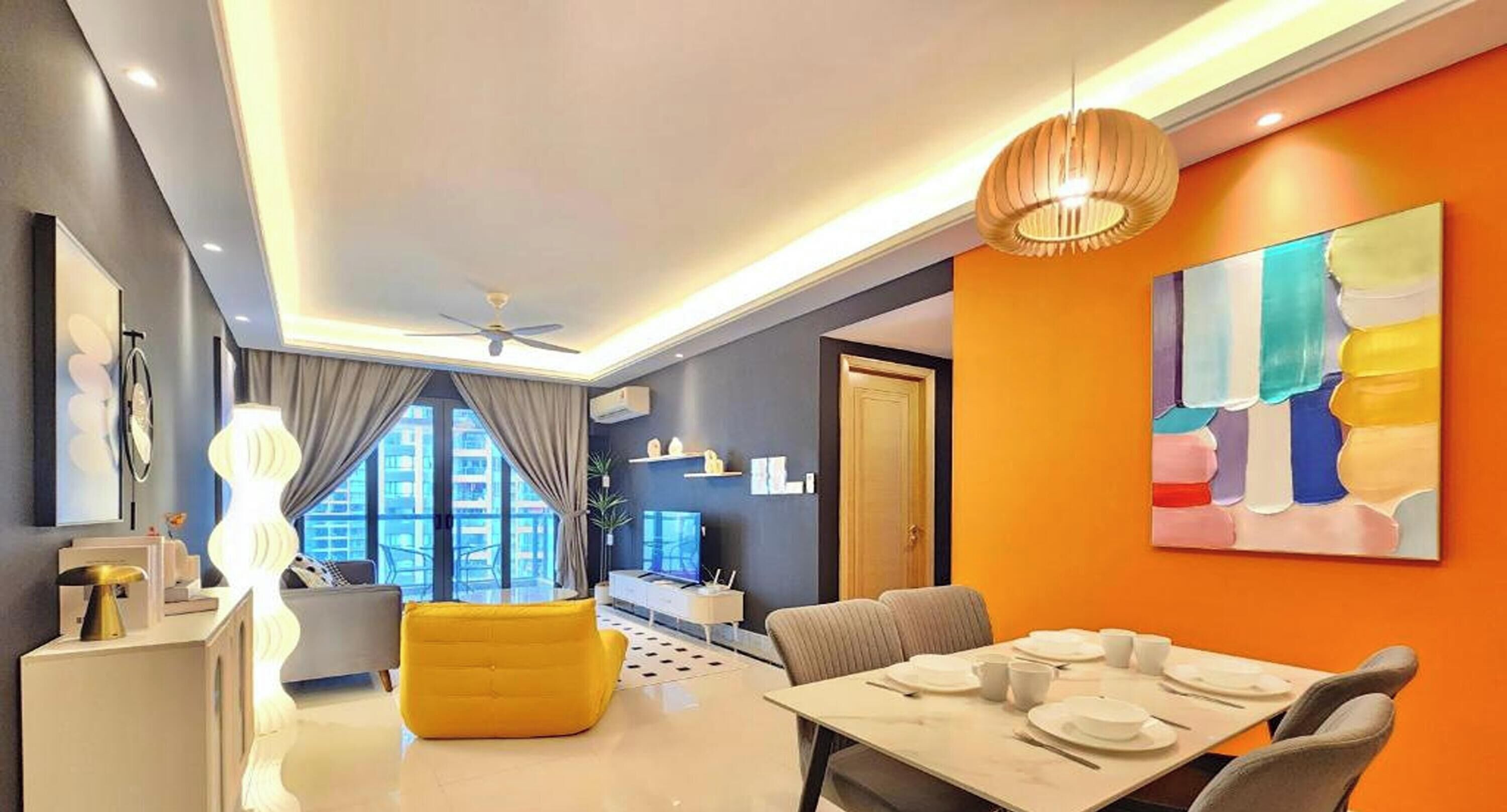 A modern living room with a dining area, a ceiling fan, and a large window.