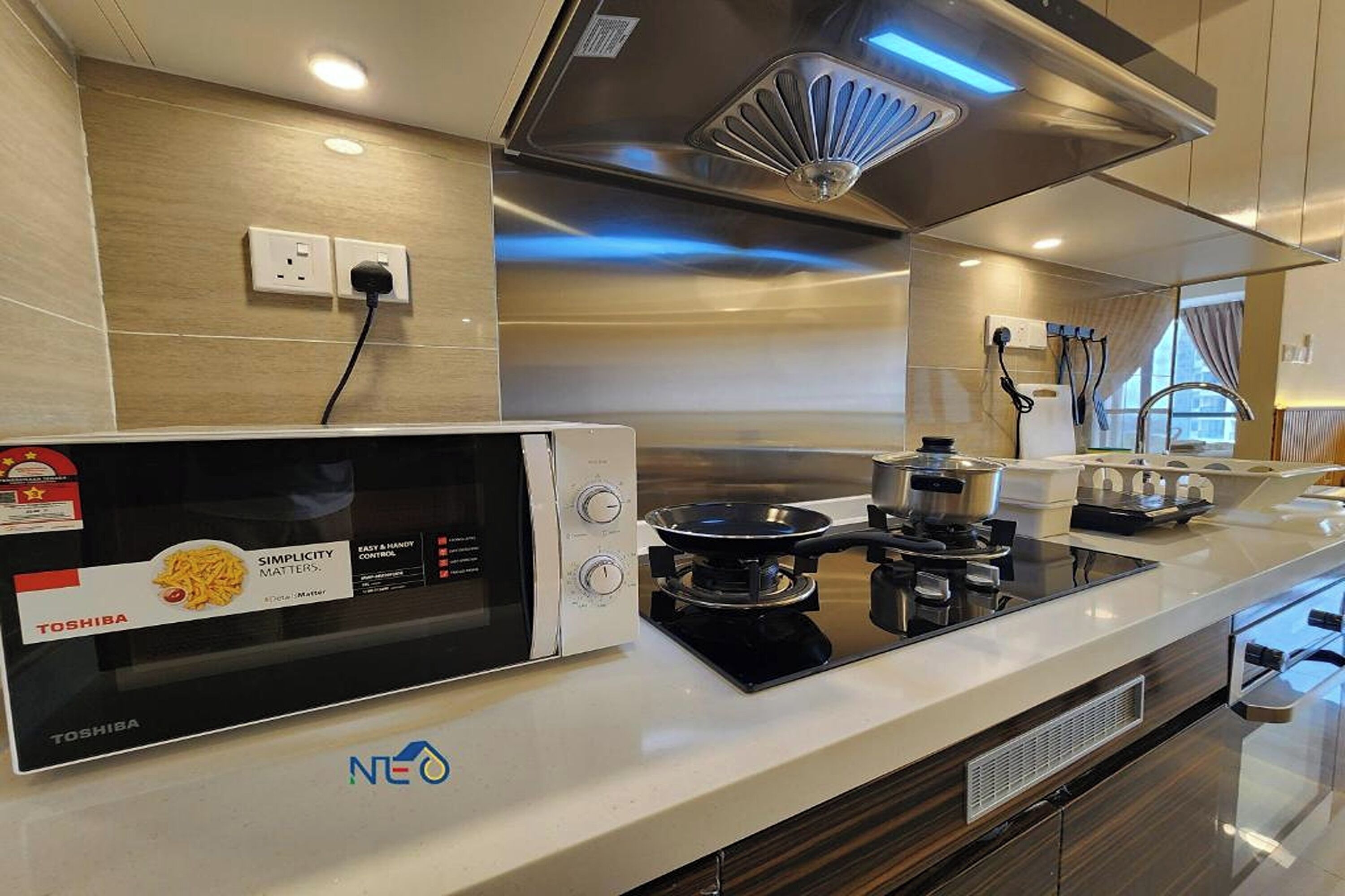 A modern kitchen with a built-in microwave, stove, and oven.